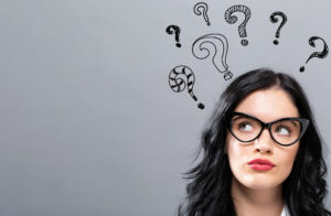 Hand draw question marks with young businesswoman -  Educational consultant debating which is best, email vs website vs social media